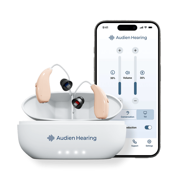Audien Ion Pro hearing aids in charging case next to smartphone app interface for volume control